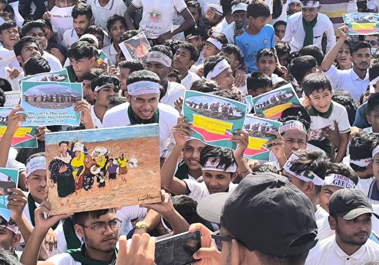 Rohingya children and adults hold placards and chant for their right to return home during a peaceful rally in Cox’s Bazar refugee camp.